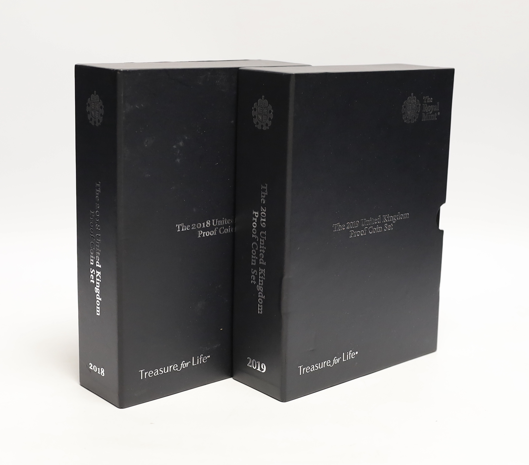 Two Royal Mint UK QEII Proof coin sets for 2018 and 2019, each containing definitive and commemorative coins, 2 cases